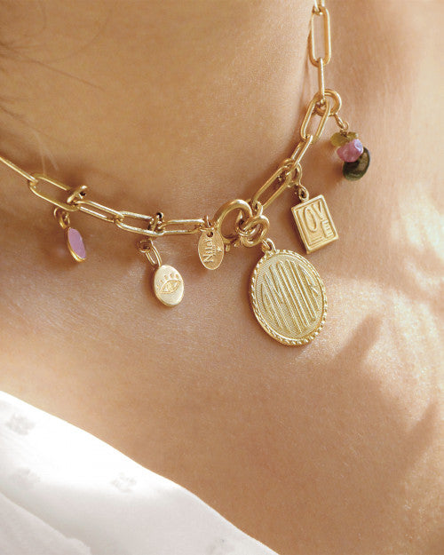 femme portant le collier pure de chez nilai personnalisé avec des pendentifs